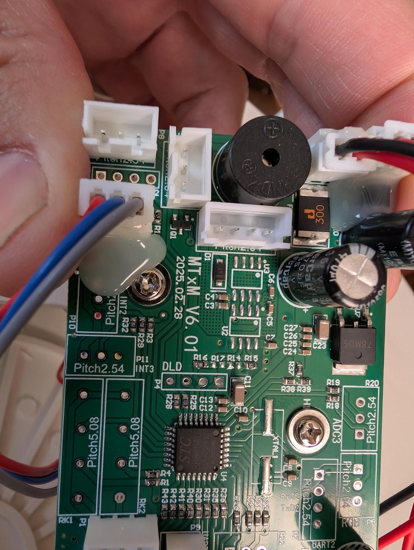 June 23: ComXim MTxM_V6.01 board left side. Board date: 2025.02.28. STC 8H8K64U MCU center, buzzer top-left, multiple JST motor connectors.